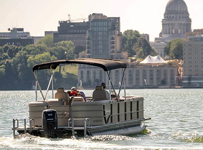 Pontoon boat infront of a city